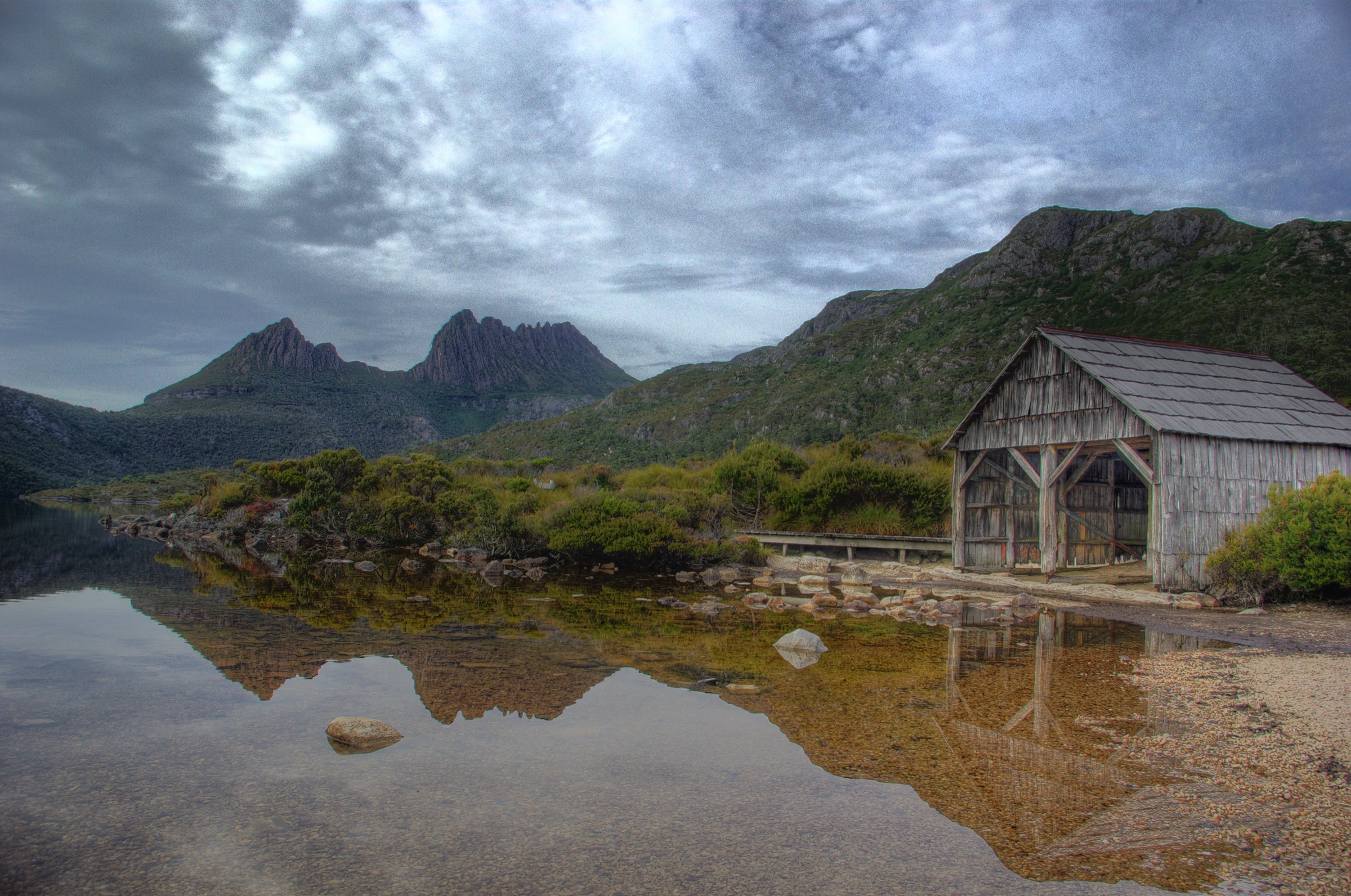 Cradle Mountain reflected in Dove Lake with the historic boatshed in the foreground