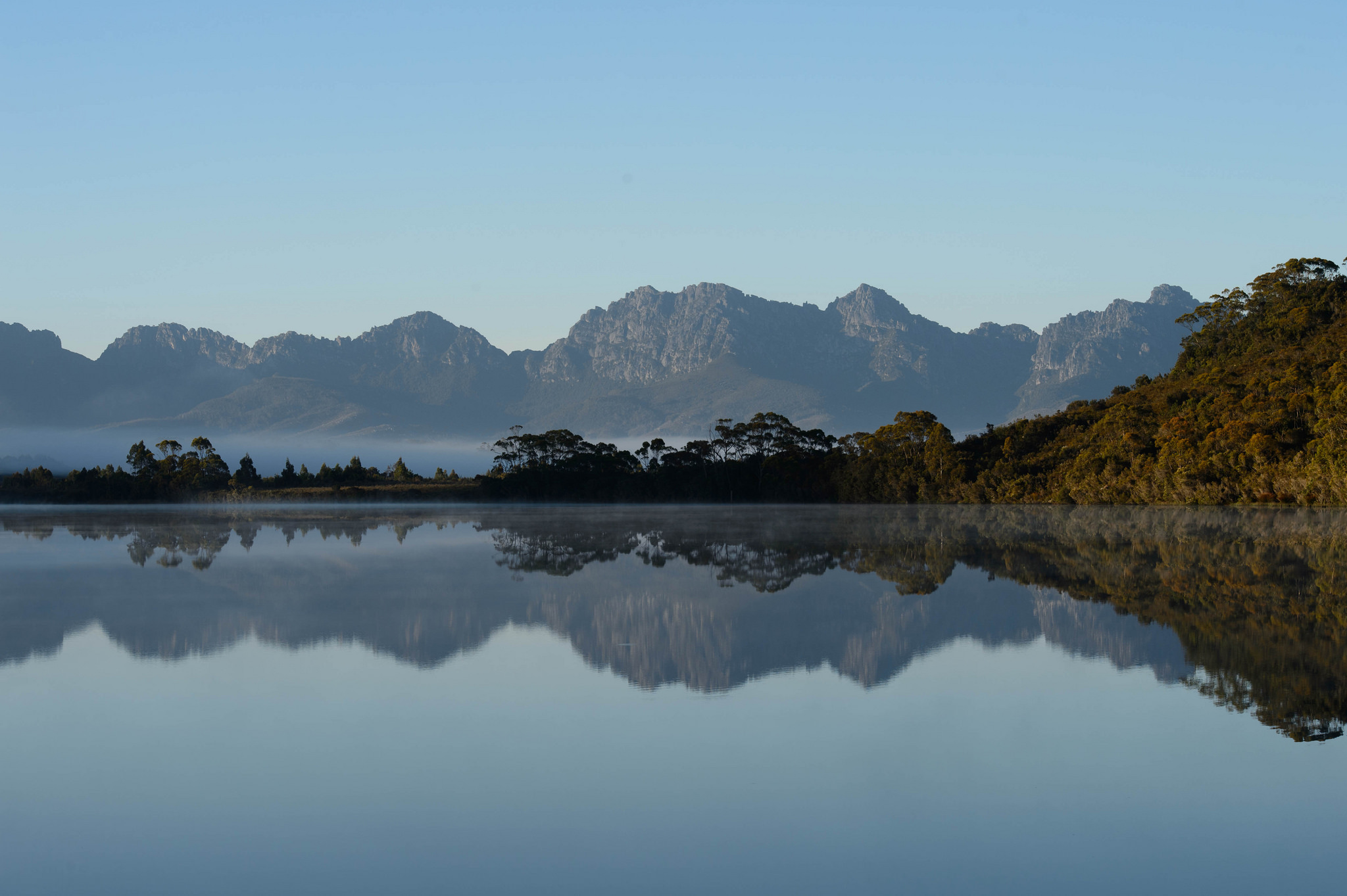 Edgar Pond in Southwest National Park, Tasmania, with quartzite ranges and buttongrass moorland visible