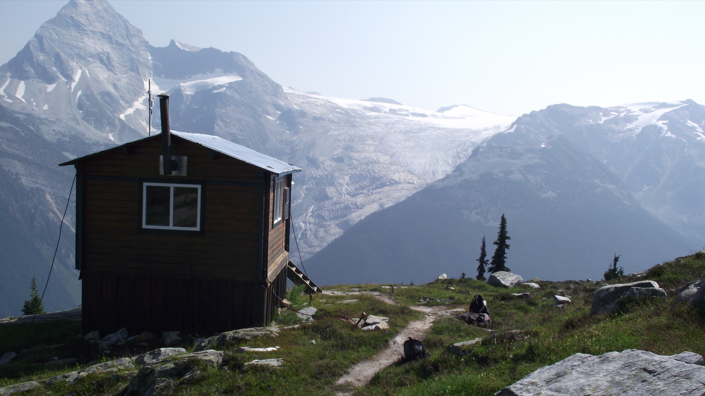 Hiker on the open alpine tundra of Abbott Ridge above the Illecillewaet valley, Glacier National Park
