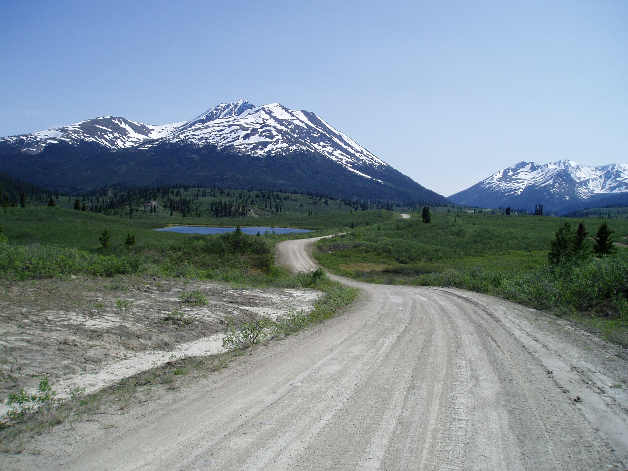 The South Canol Road climbing through open subalpine terrain near the Rose River headwaters