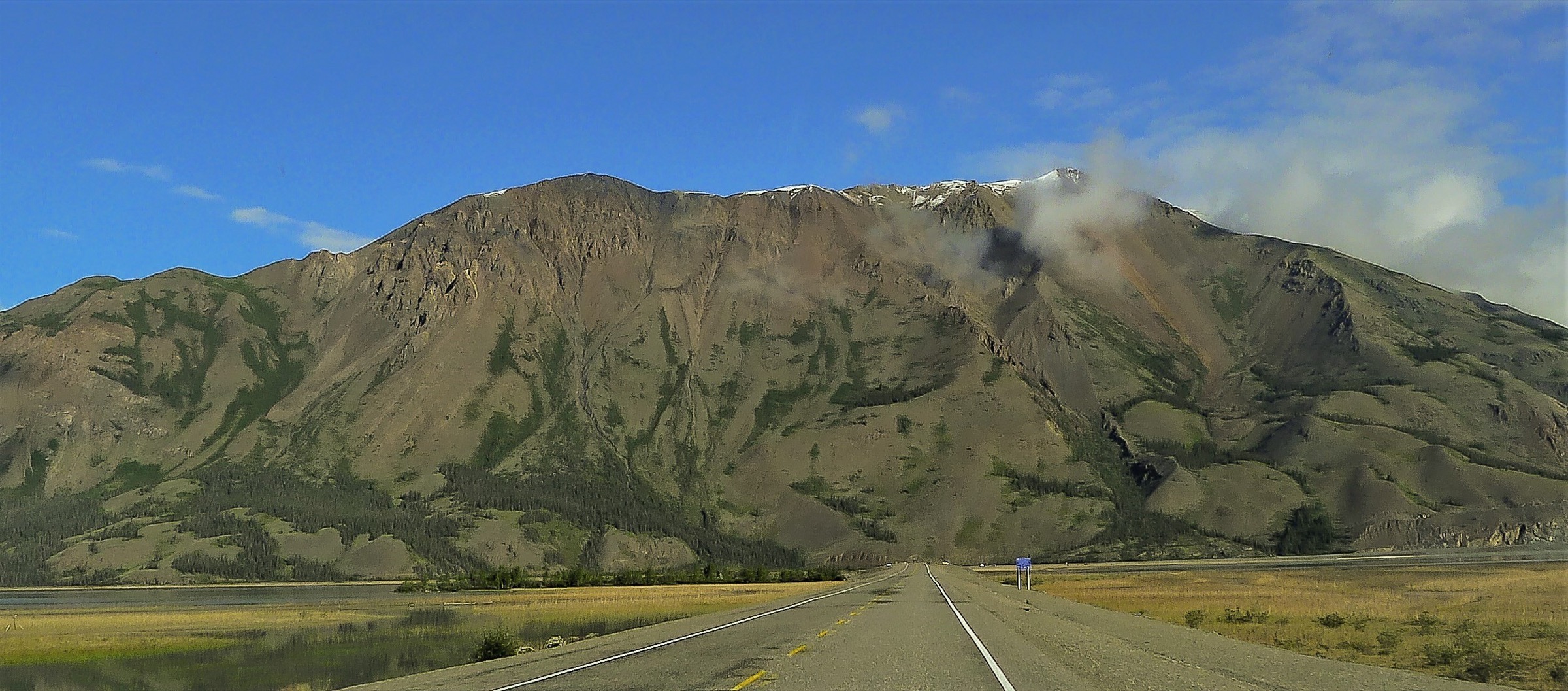 Sheep Mountain rising above the Alaska Highway at the north shore of Kluane Lake