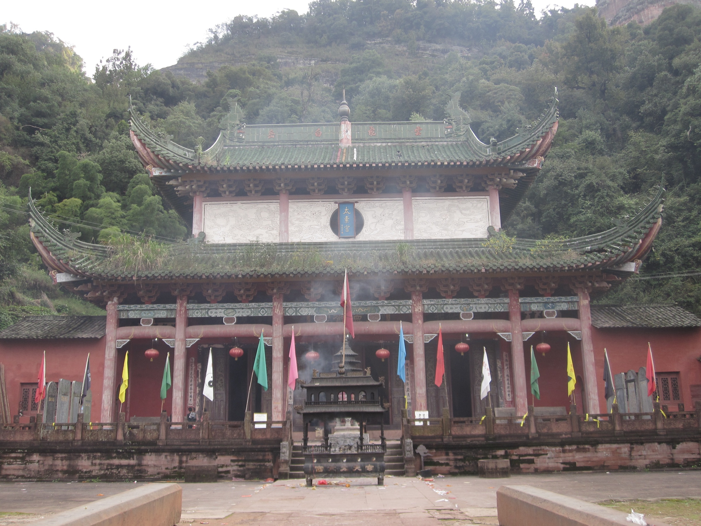 Taoist temple buildings against the red Danxia cliffs of Qiyun Mountain