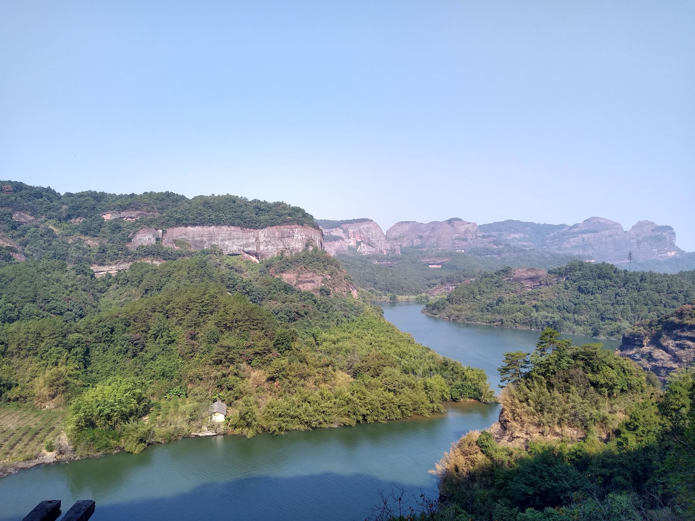 View from Jinshiyan Temple on the Changlaofeng ridge at Danxia Shan, with red sandstone cliffs falling away below
