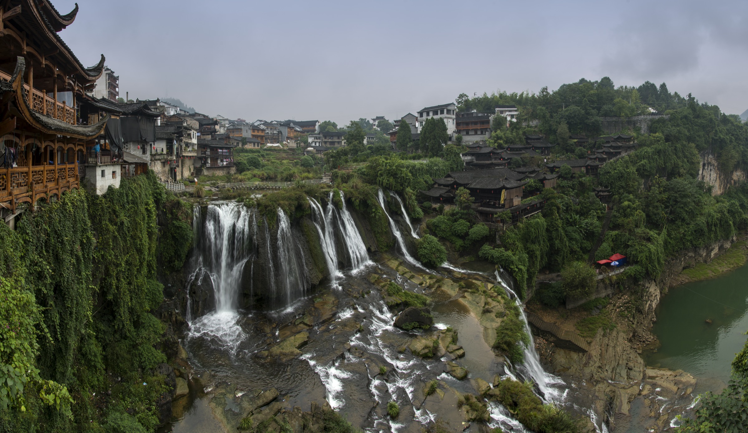 Aerial panorama of Furong Town / Wangcun and the waterfall stilt-house cluster above the Youshui River