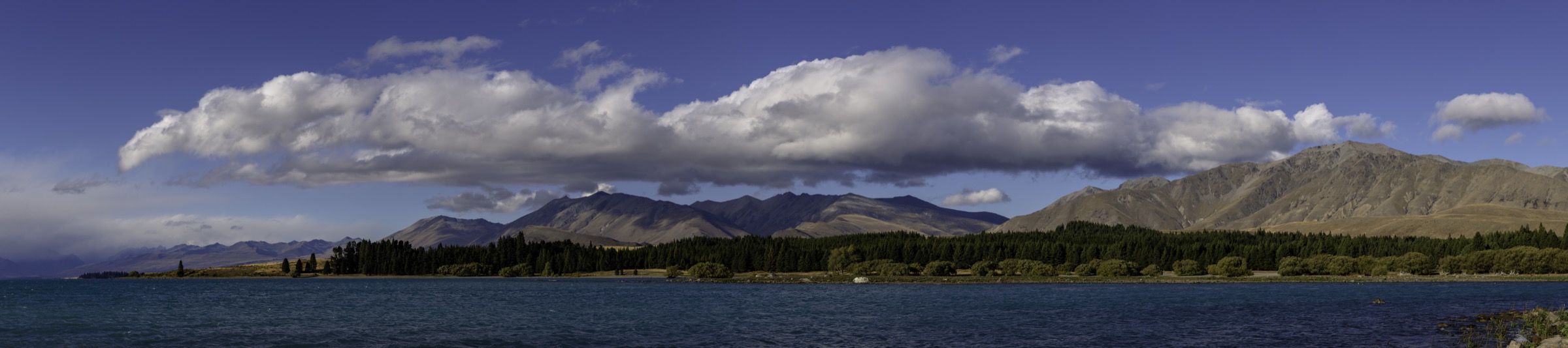 Wide panorama across Lake Pukaki with the Ben Ohau Range and Aoraki / Mount Cook at the head of the lake
