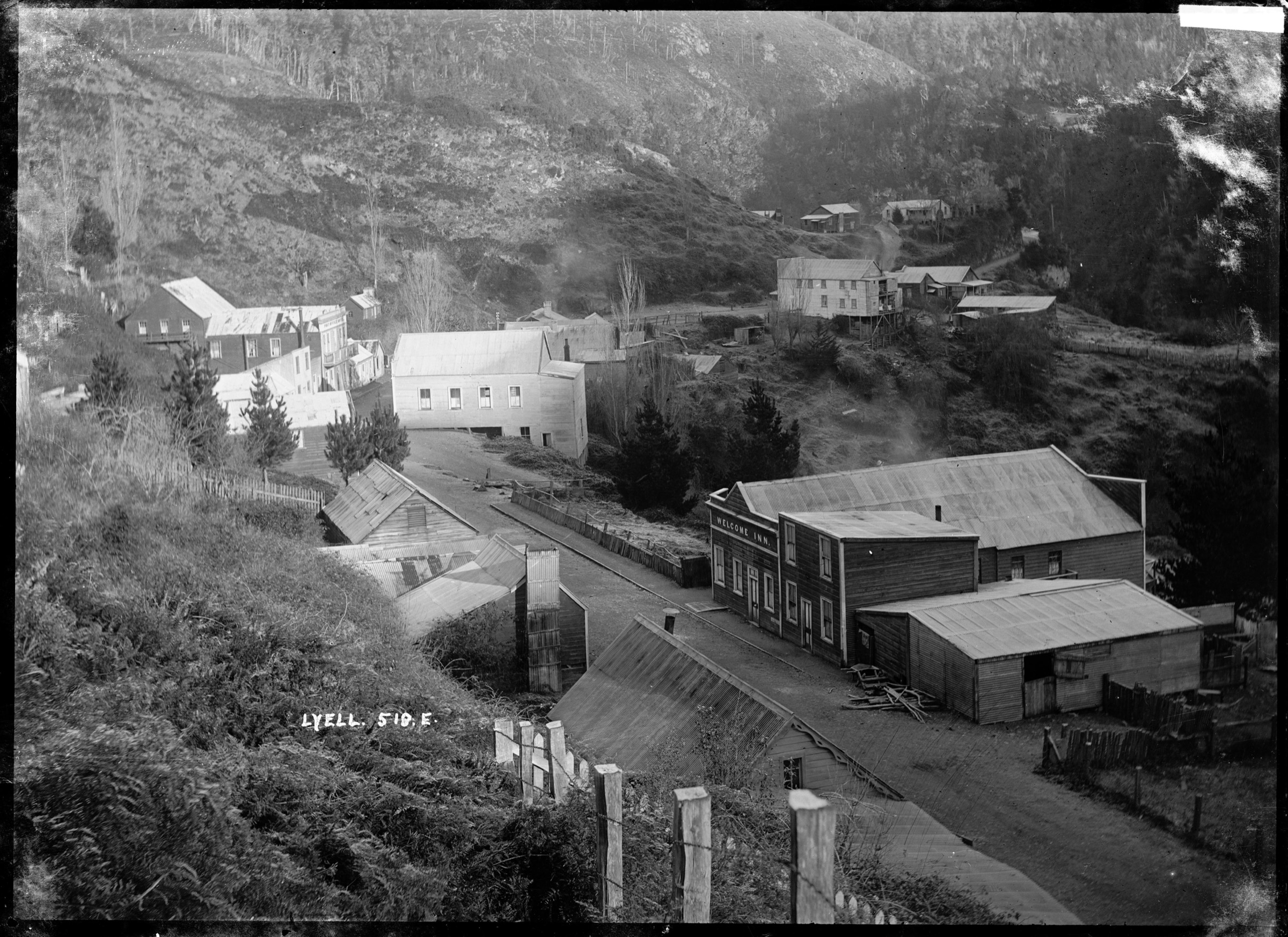 The historic Lyell settlement in the Upper Buller Gorge circa 1910, with the Welcome Inn in the foreground