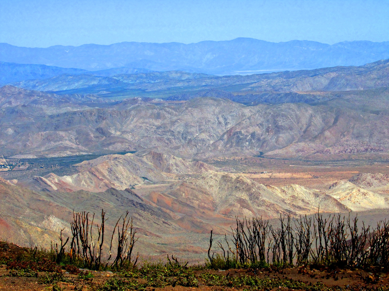 Two hikers looking out across stacked desert ridgelines north of Mt. Laguna