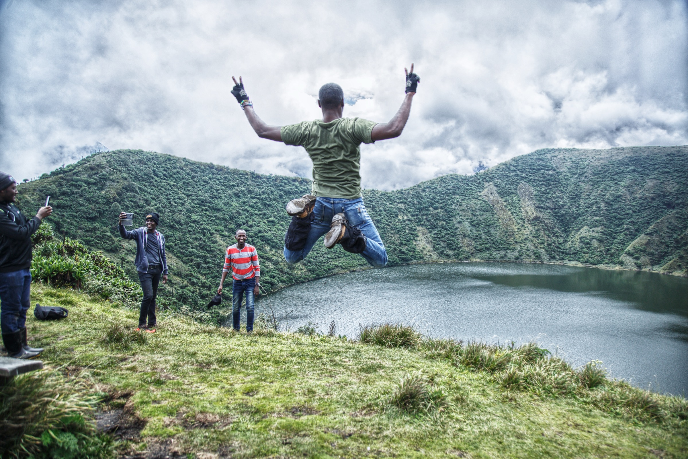 Hikers ascending Mount Bisoke through the upper forest of Volcanoes National Park, Rwanda