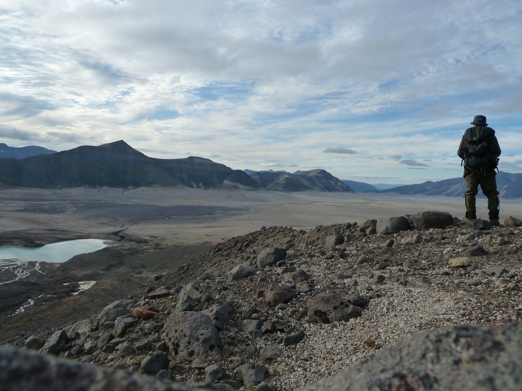 Hiker overlooking the ash-floored Valley of Ten Thousand Smokes above East Mageik Lake