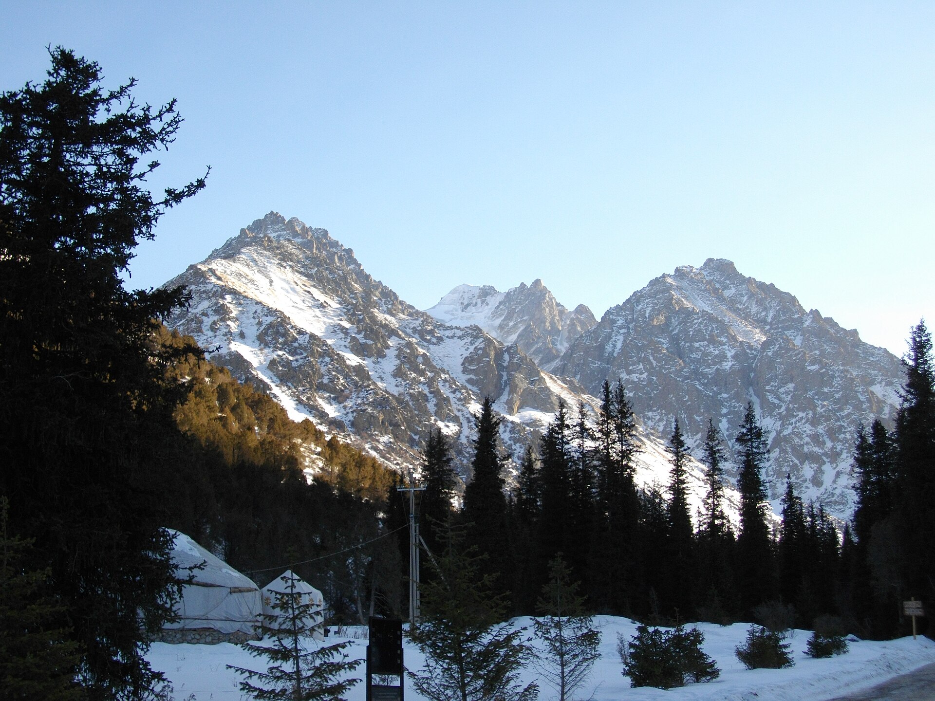 Snow-covered peaks and dark spruce forest in Ala-Archa National Park