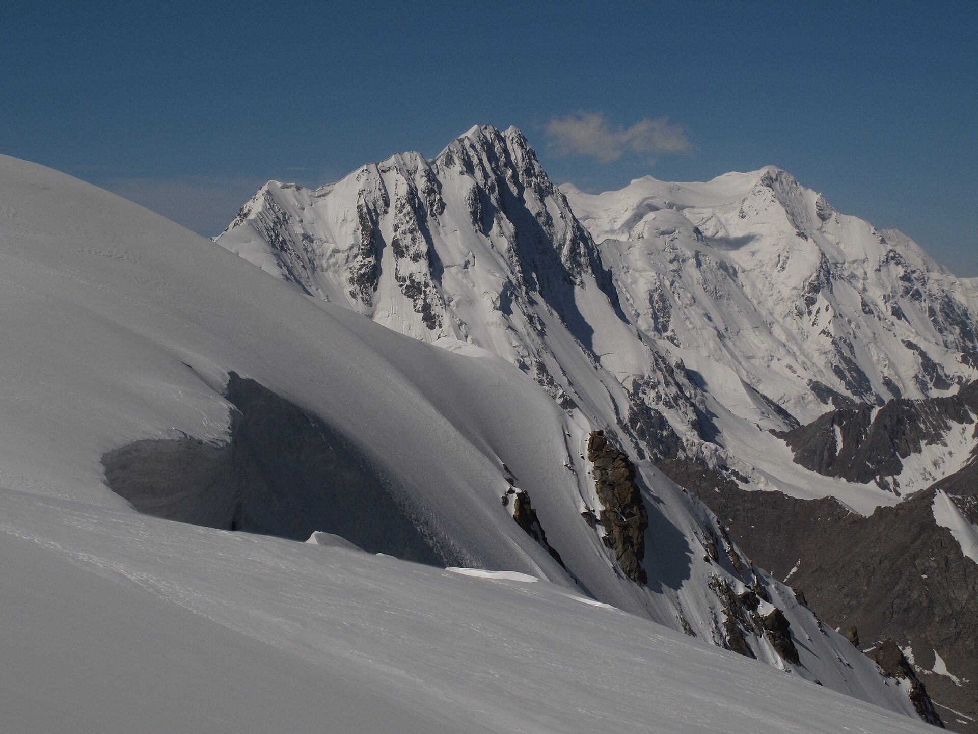 Djigit and Pik Karakol rising above snow-filled couloirs