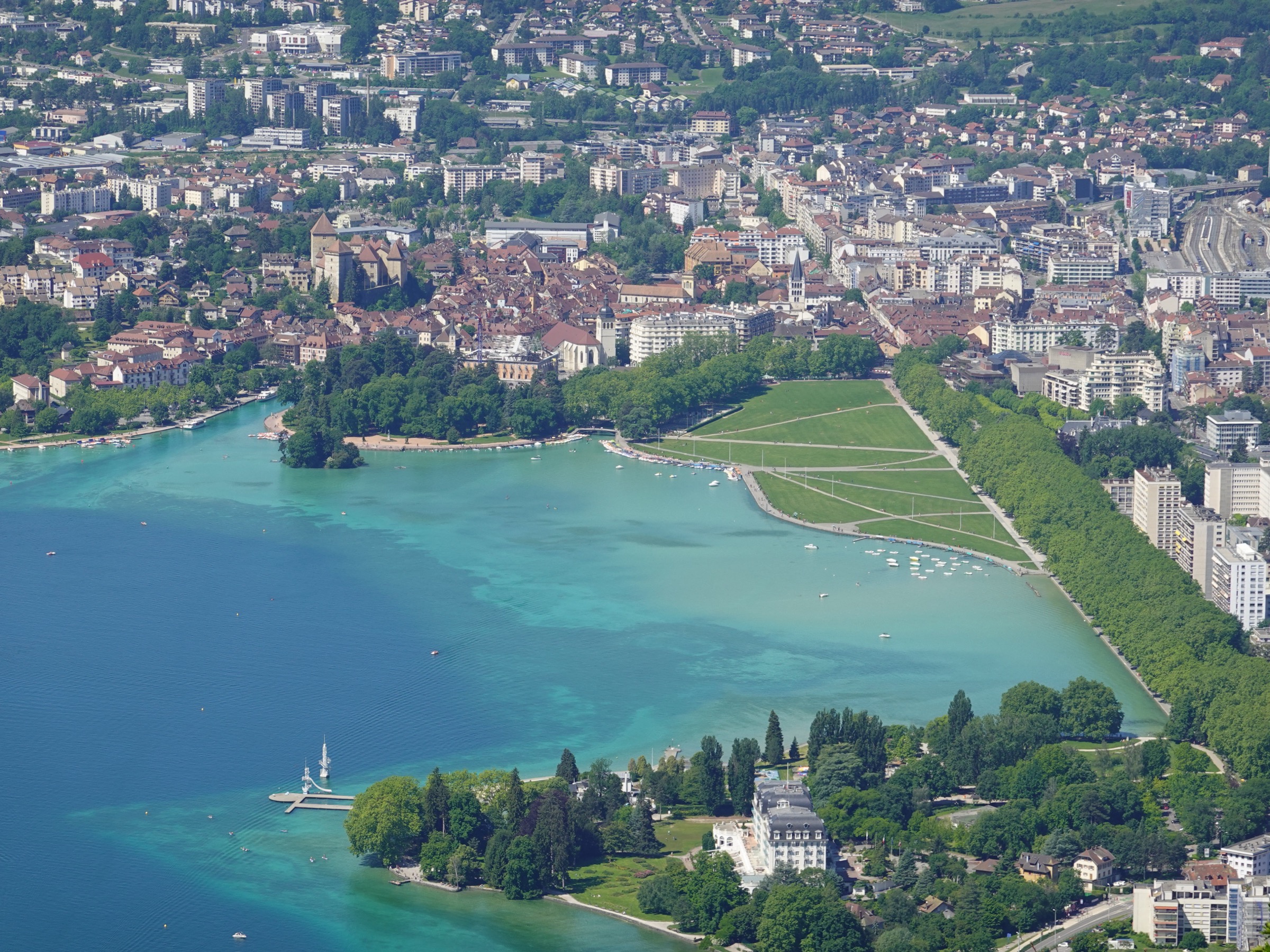 Annecy old town and the Pâquier gardens beside Lac d'Annecy with the surrounding ridges rising beyond