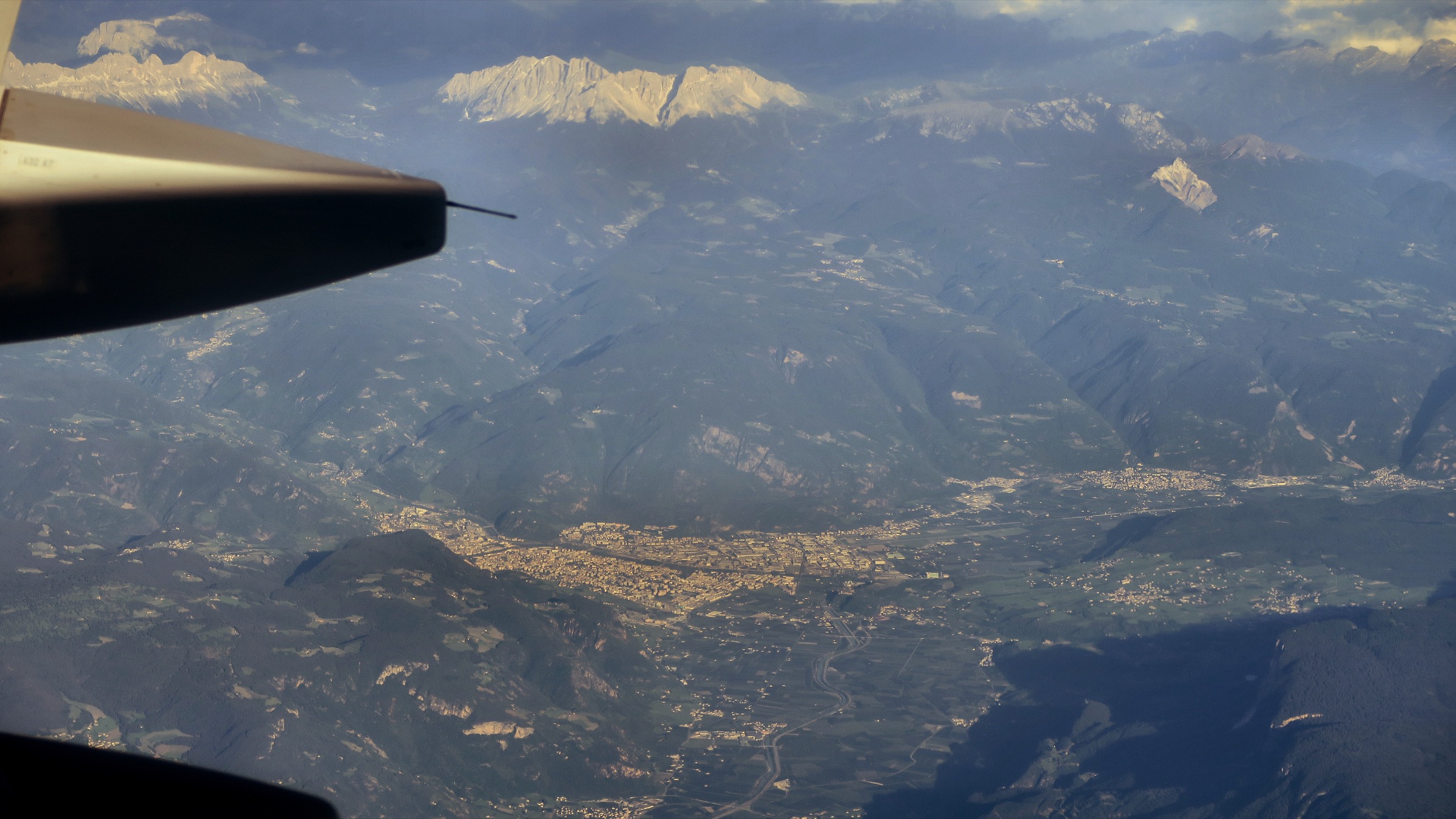 Aerial view of Bolzano with the Isarco and Adige valleys and Dolomite foothills framing the city