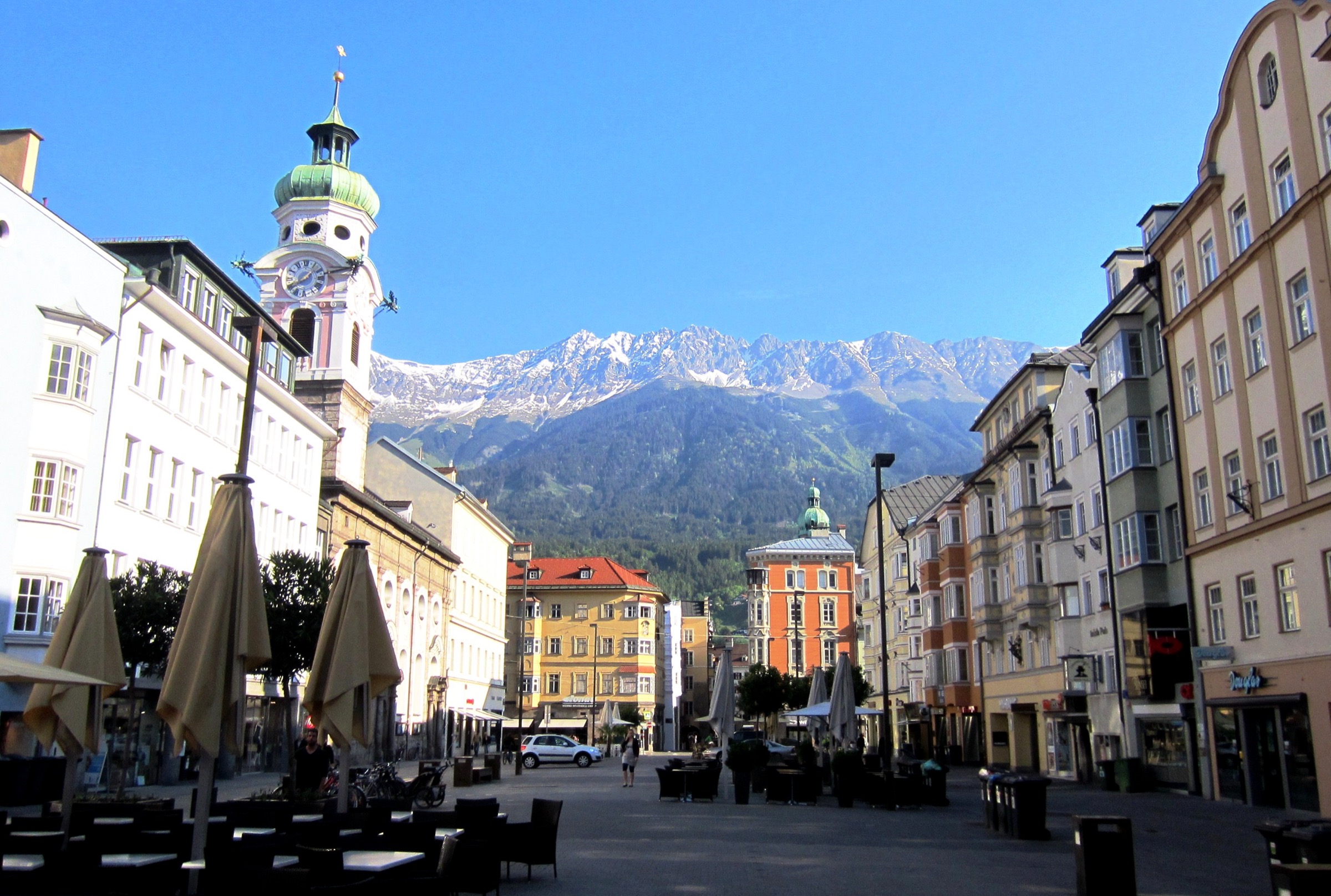 View up Maria-Theresien-Straße in central Innsbruck with the snow-capped Nordkette rising directly above the northern end of the street