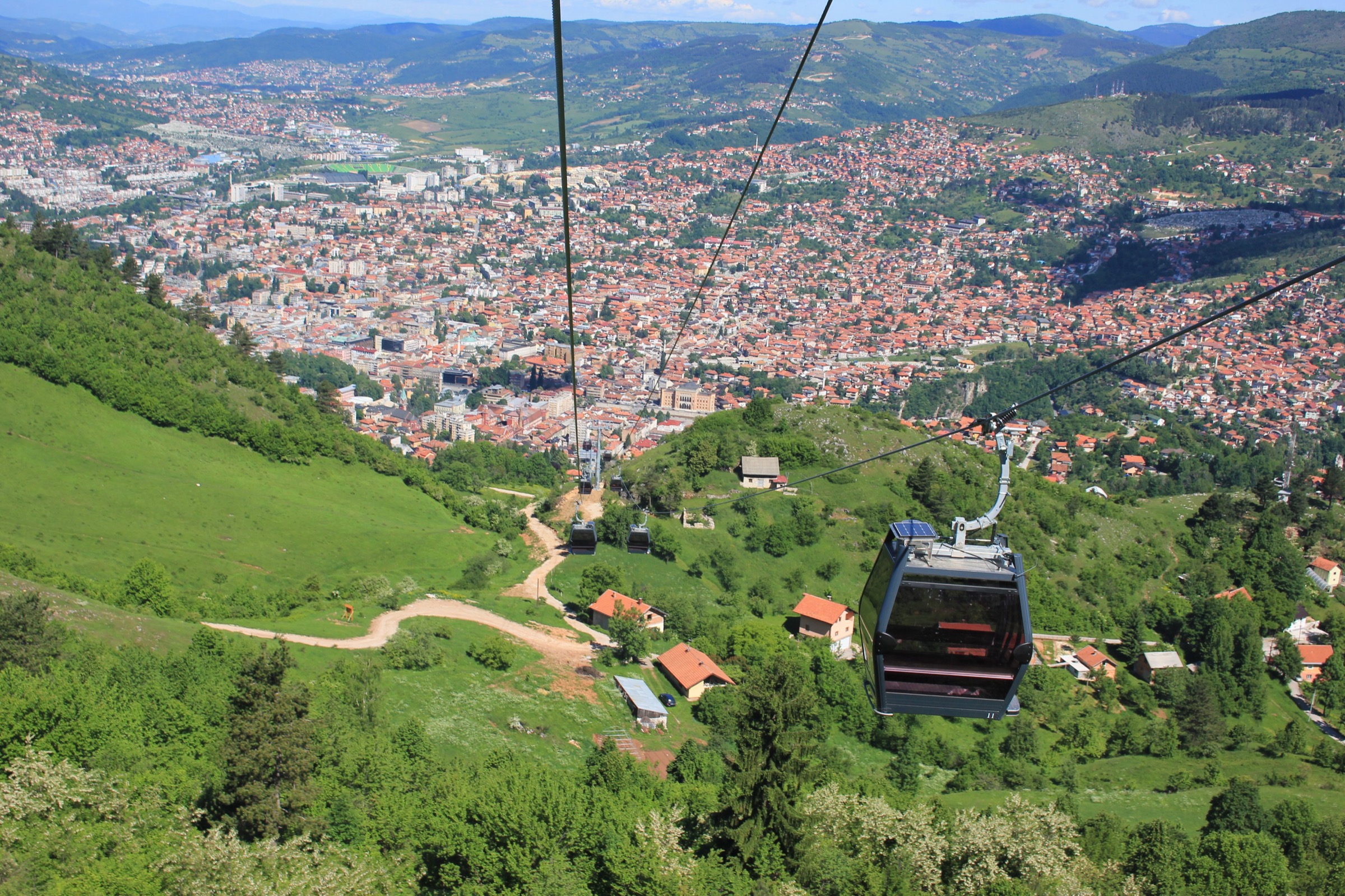 A cabin of the reopened Trebević cable car climbing above the wooded slopes on the edge of Sarajevo