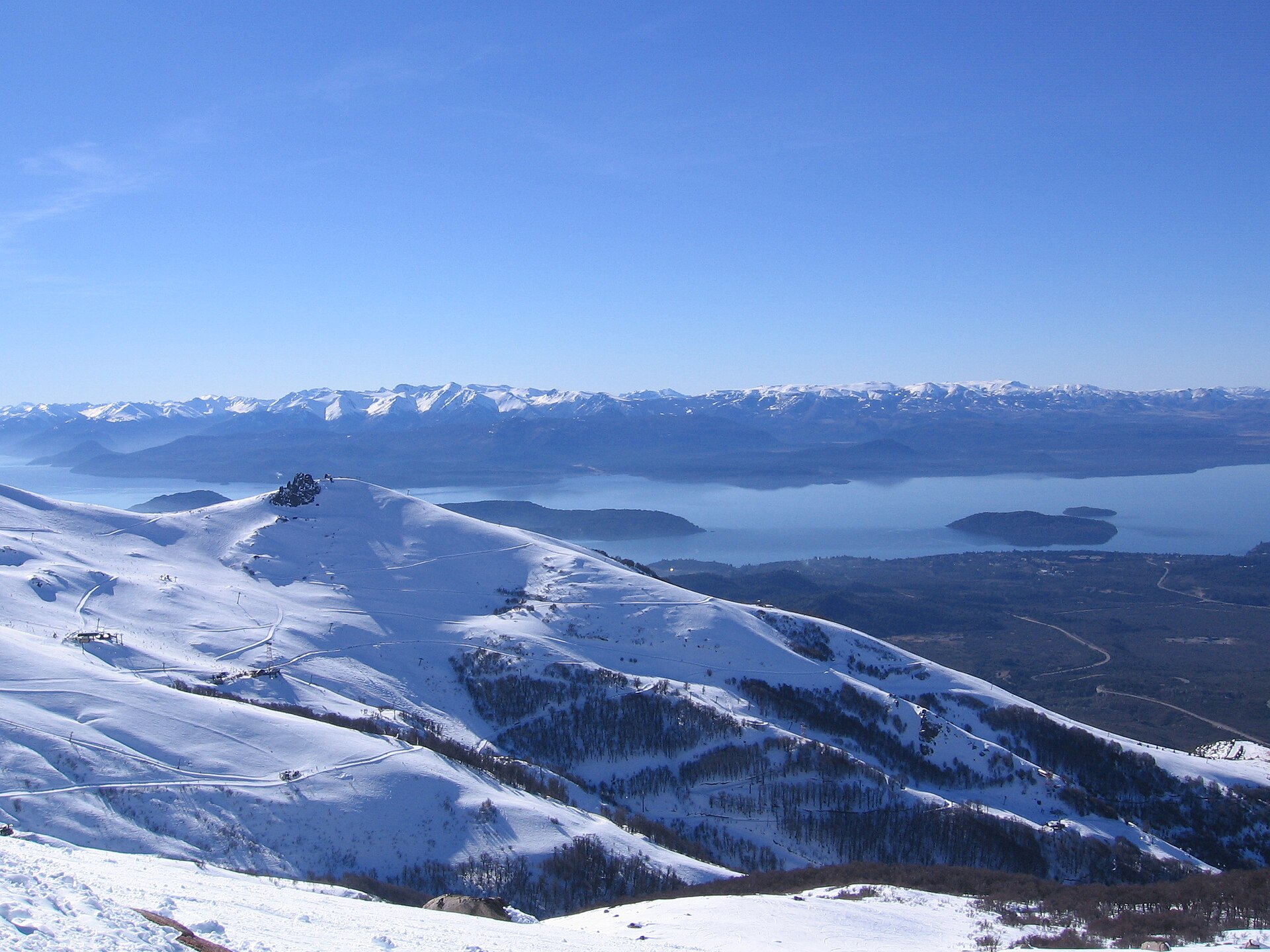 Snow-covered Cerro Catedral ridges above blue lakes in Patagonia