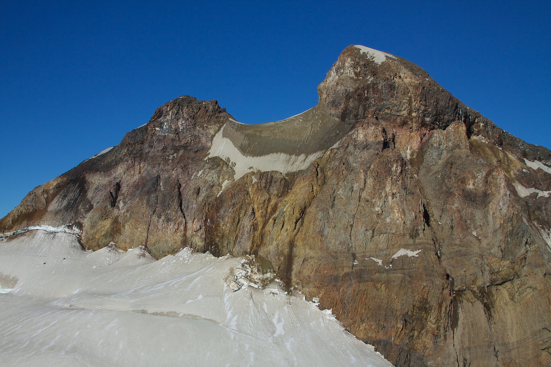 The steep glaciated International Peak of Cerro Tronador beneath a clear blue sky