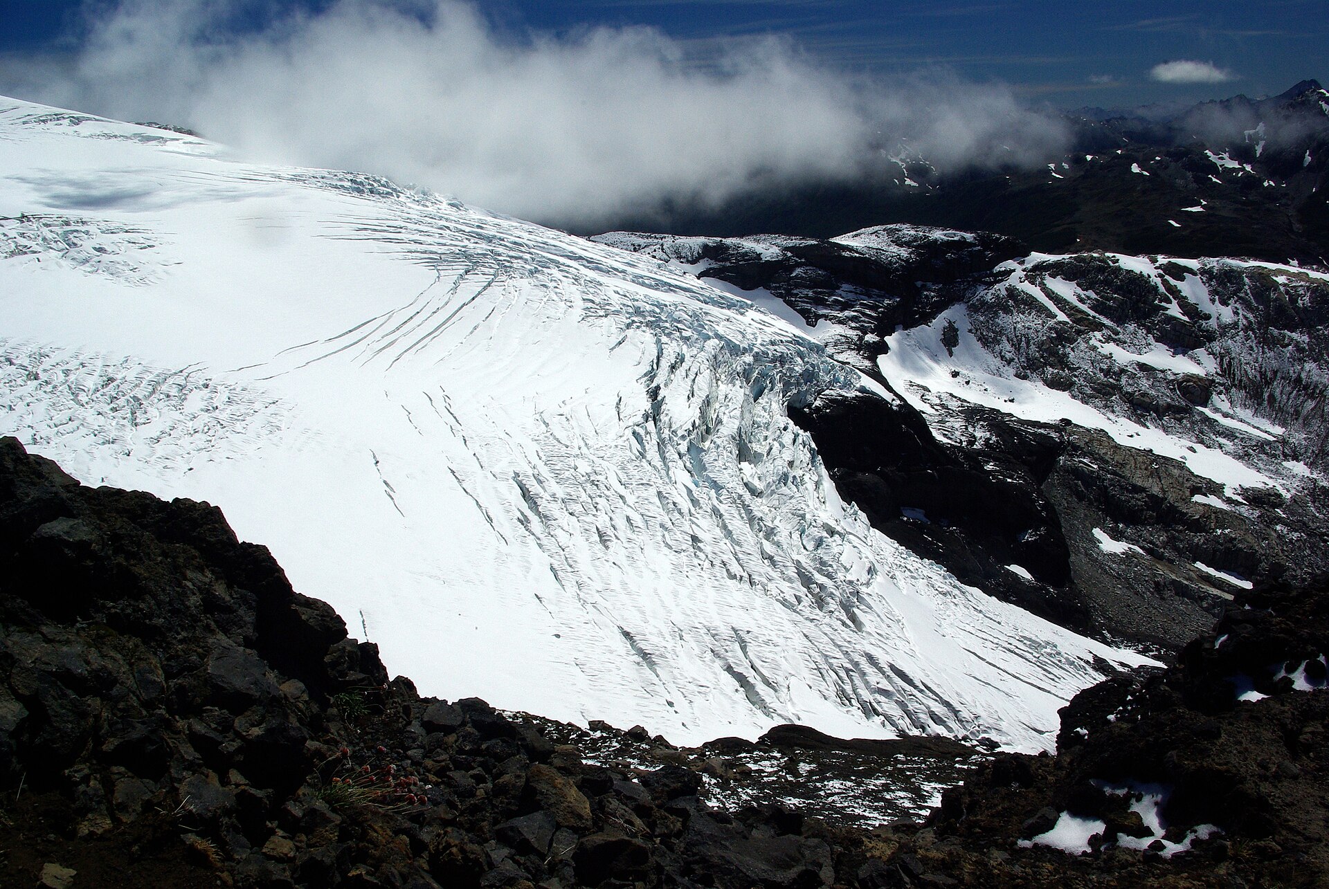 Crevassed Alerce Glacier and snowfields on Cerro Tronador beneath cloud