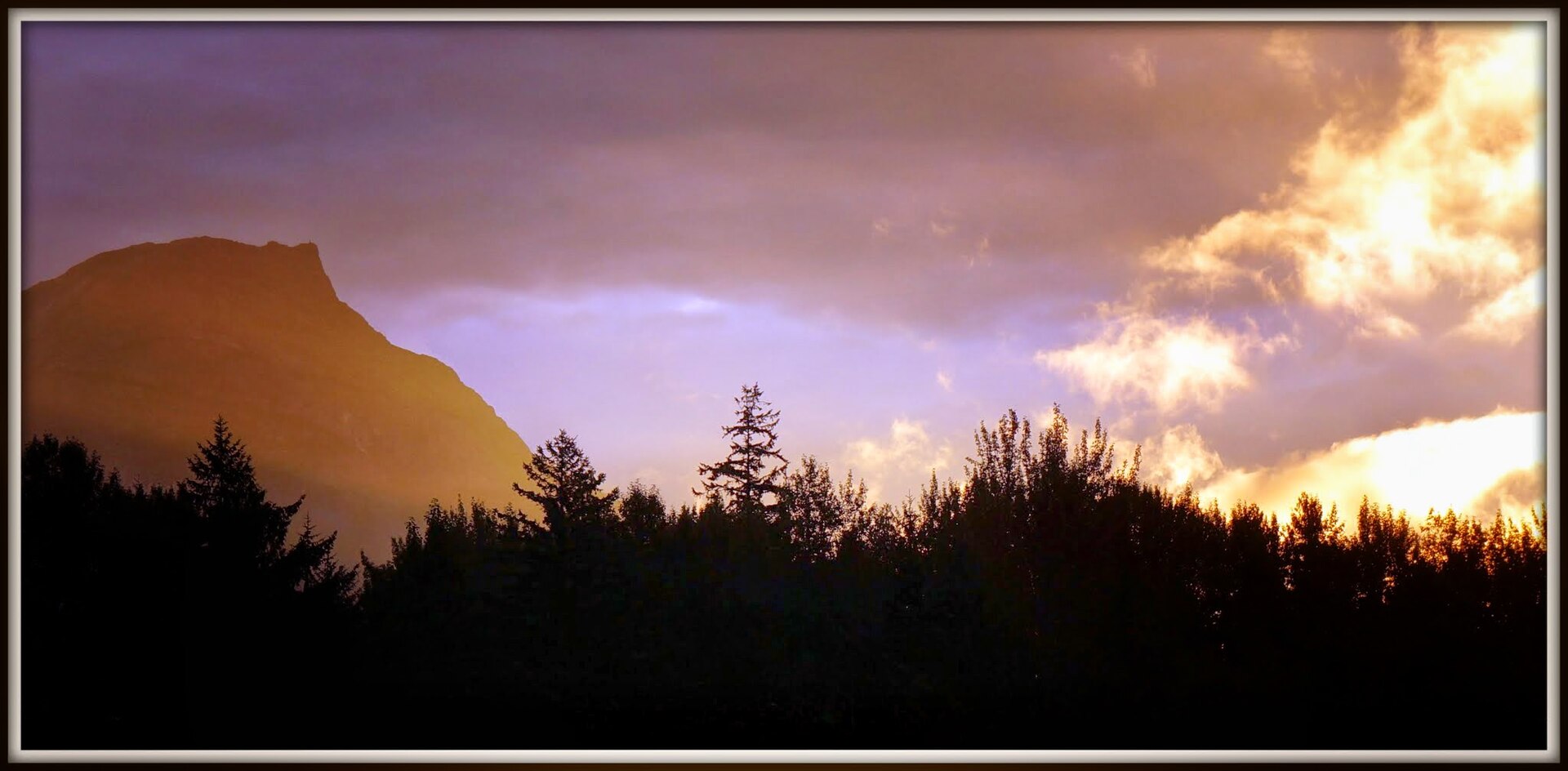 Sunset light breaking through clouds over the Bella Coola Valley