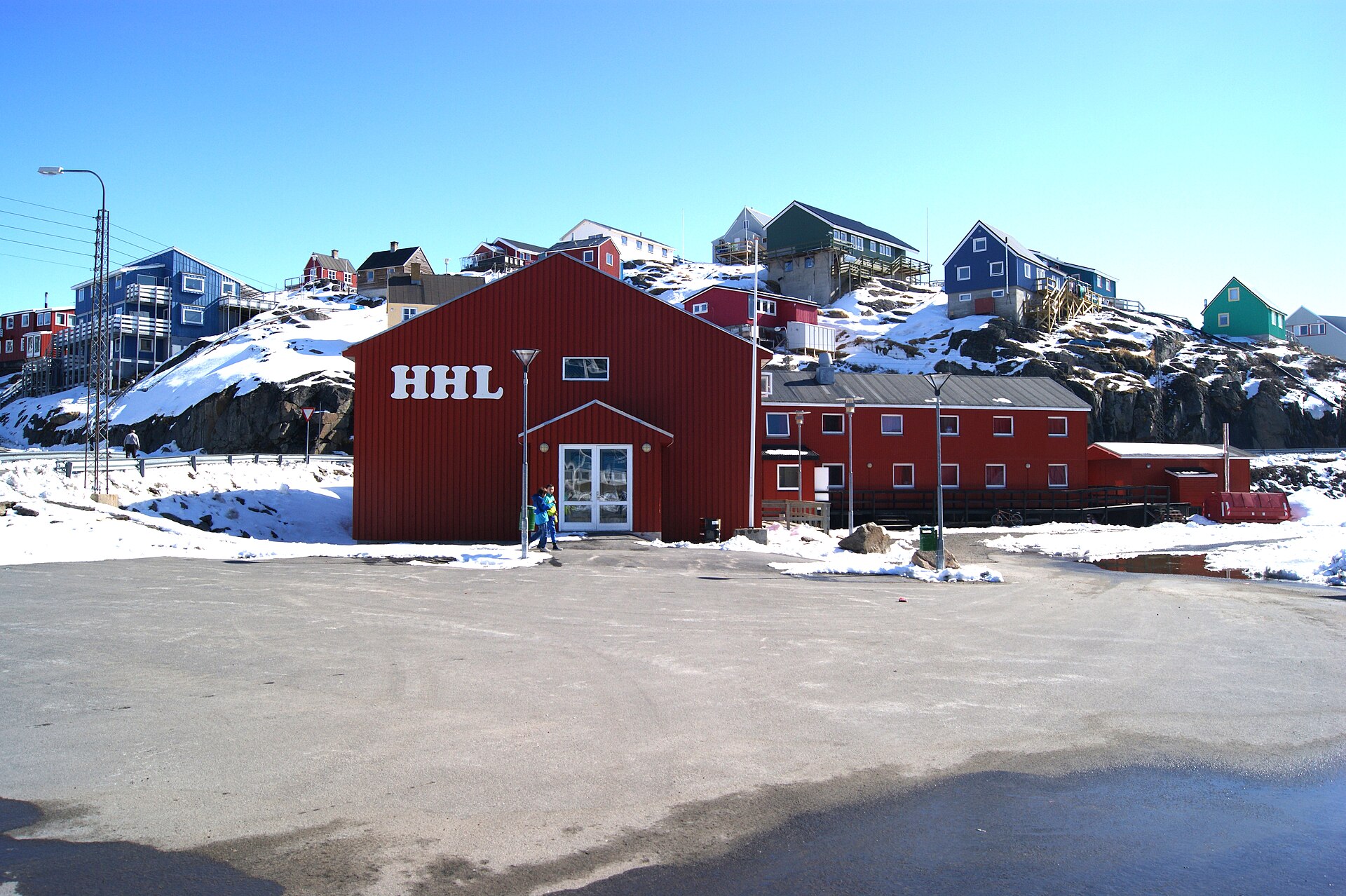 Snow-covered buildings and rocky hills in Maniitsoq during winter
