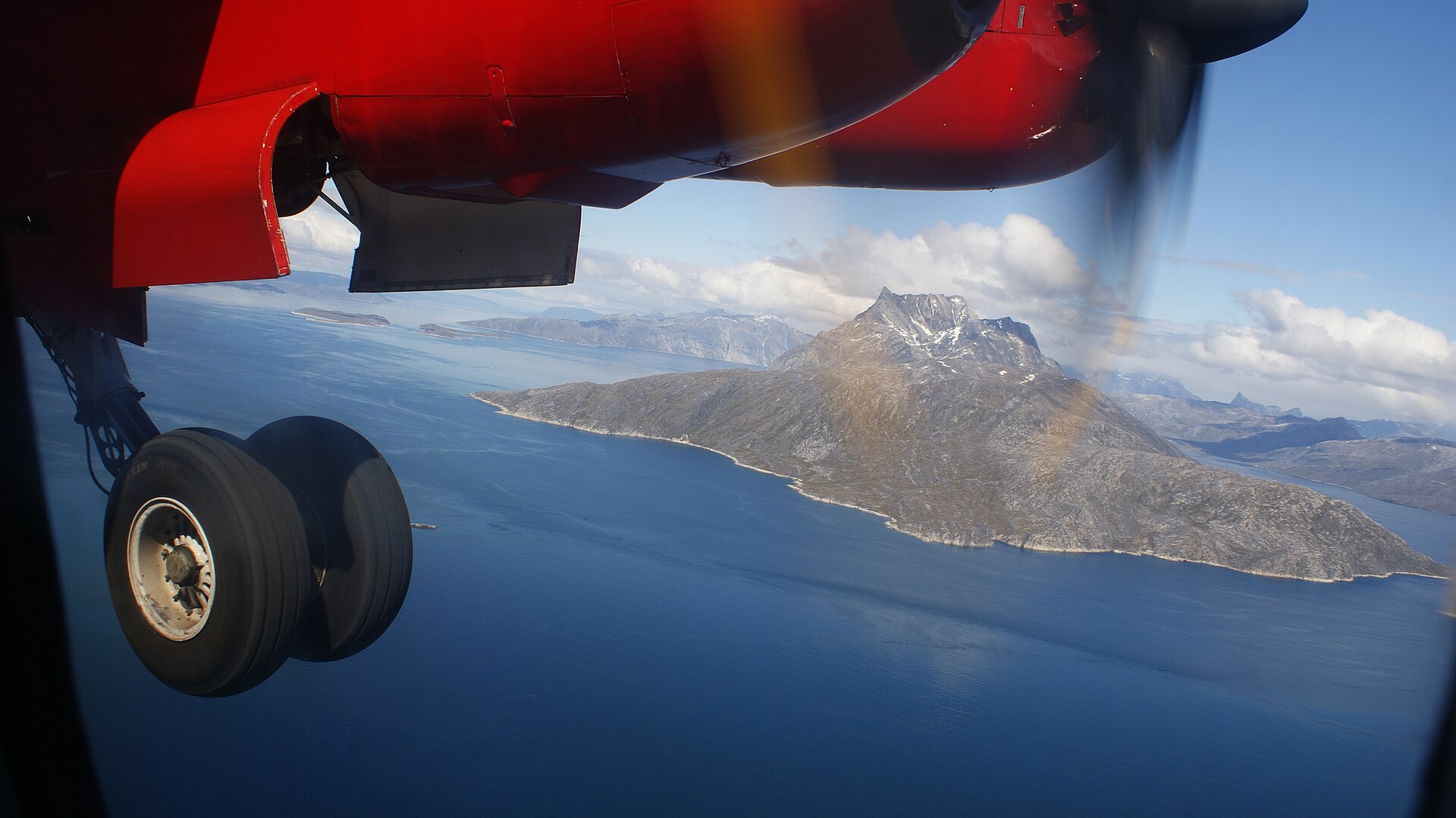 An Air Greenland aircraft approaching Nuuk with Sermitsiaq mountain behind