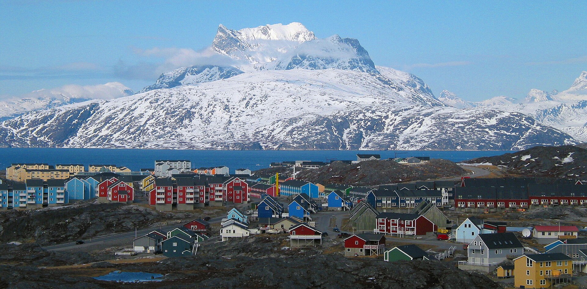 Snow-covered Nuuk below the double summit of Sermitsiaq mountain