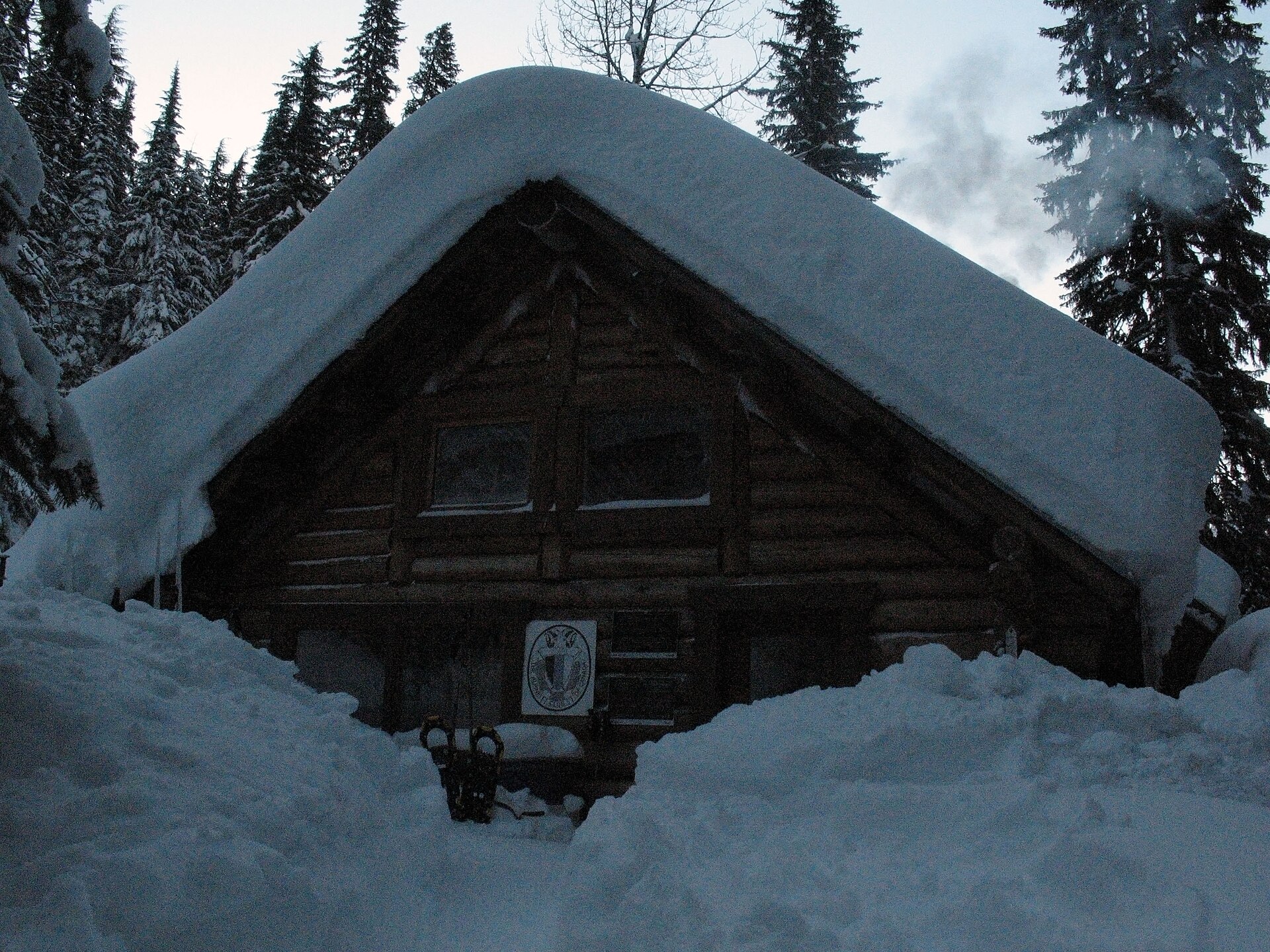 The historic A.O. Wheeler Hut buried in winter snow
