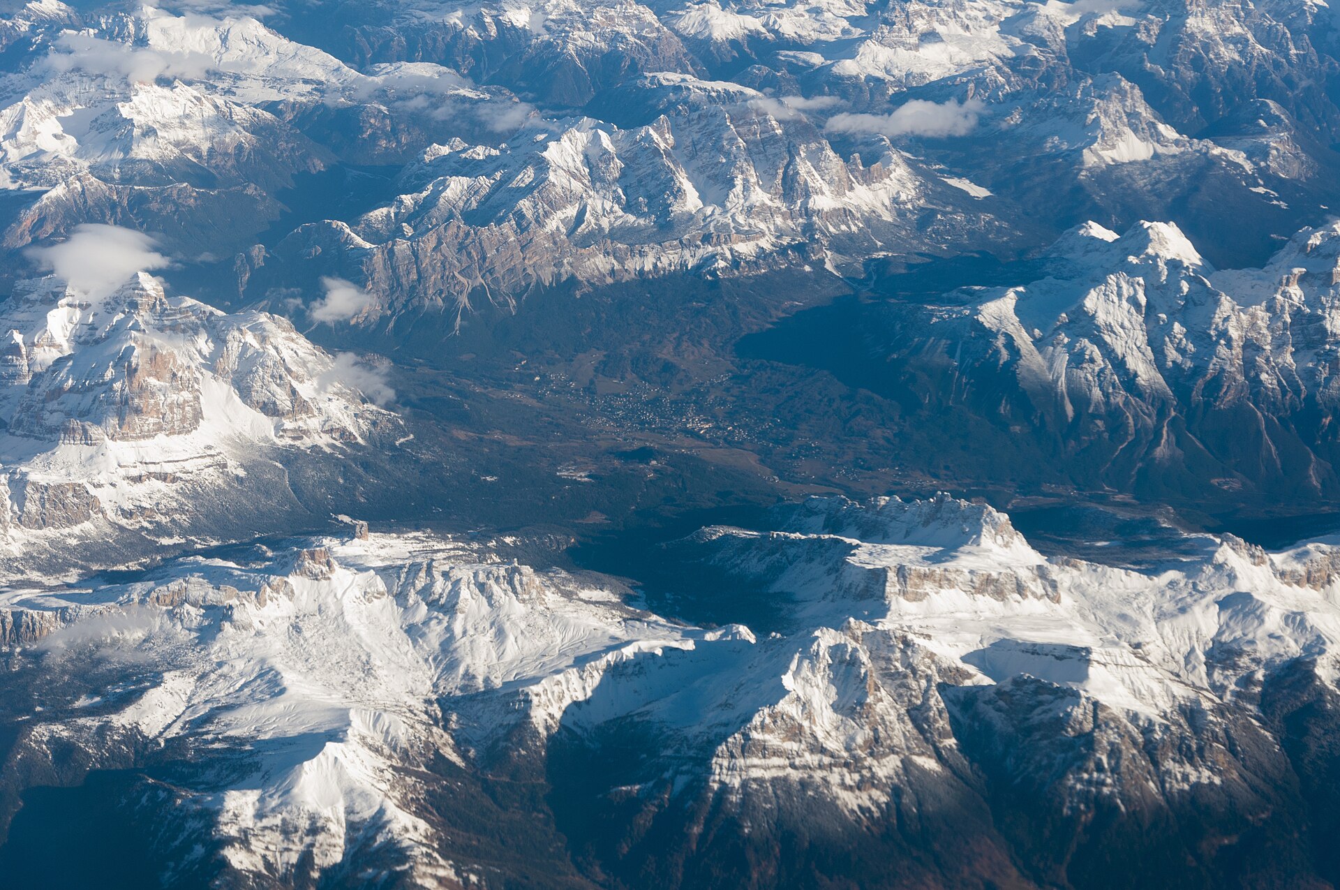 Winter aerial view across the snow-covered Dolomites in Belluno province