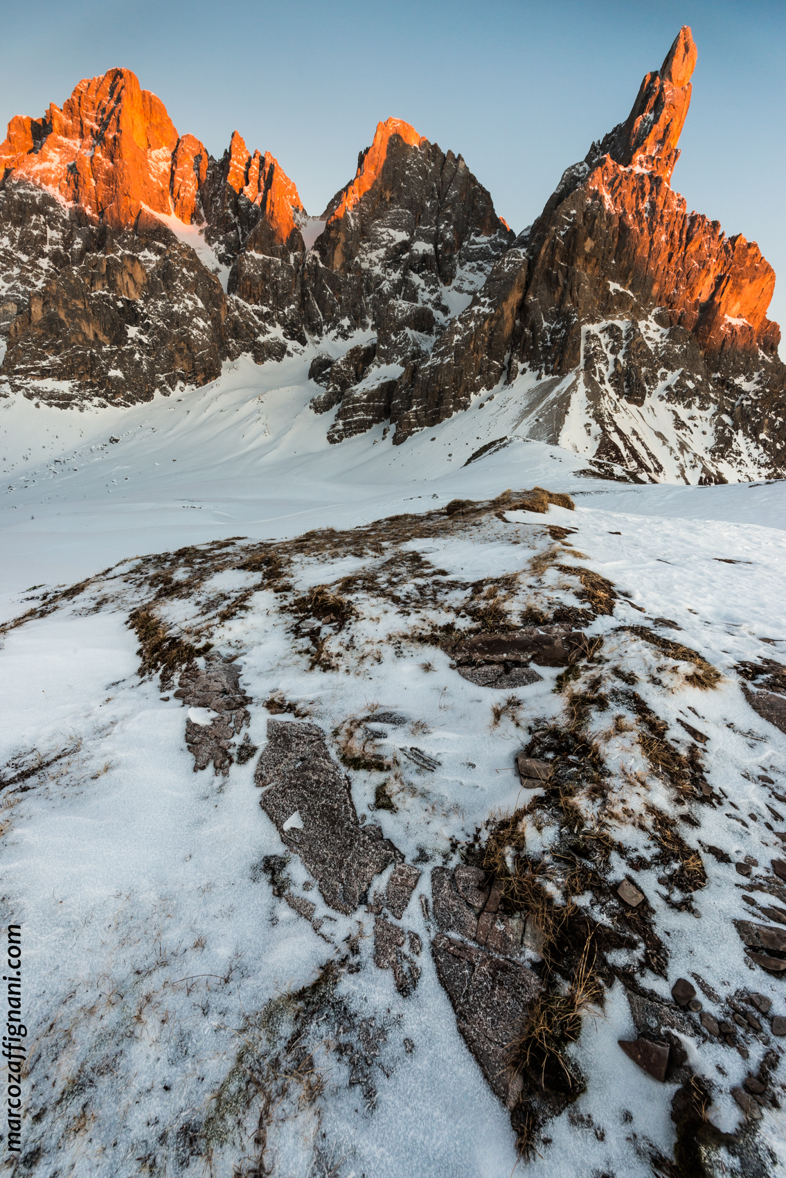 The Pale di San Martino glowing above Passo Rolle on a winter evening