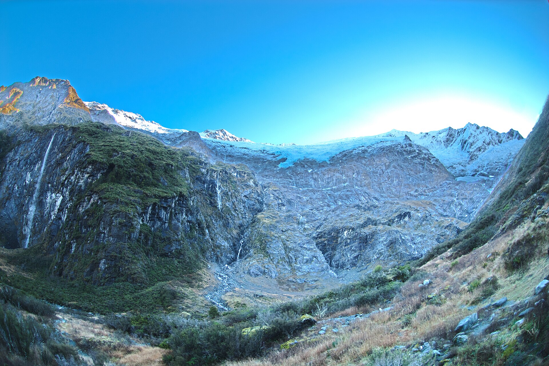 The fractured ice of Rob Roy Glacier beneath a bright blue sky