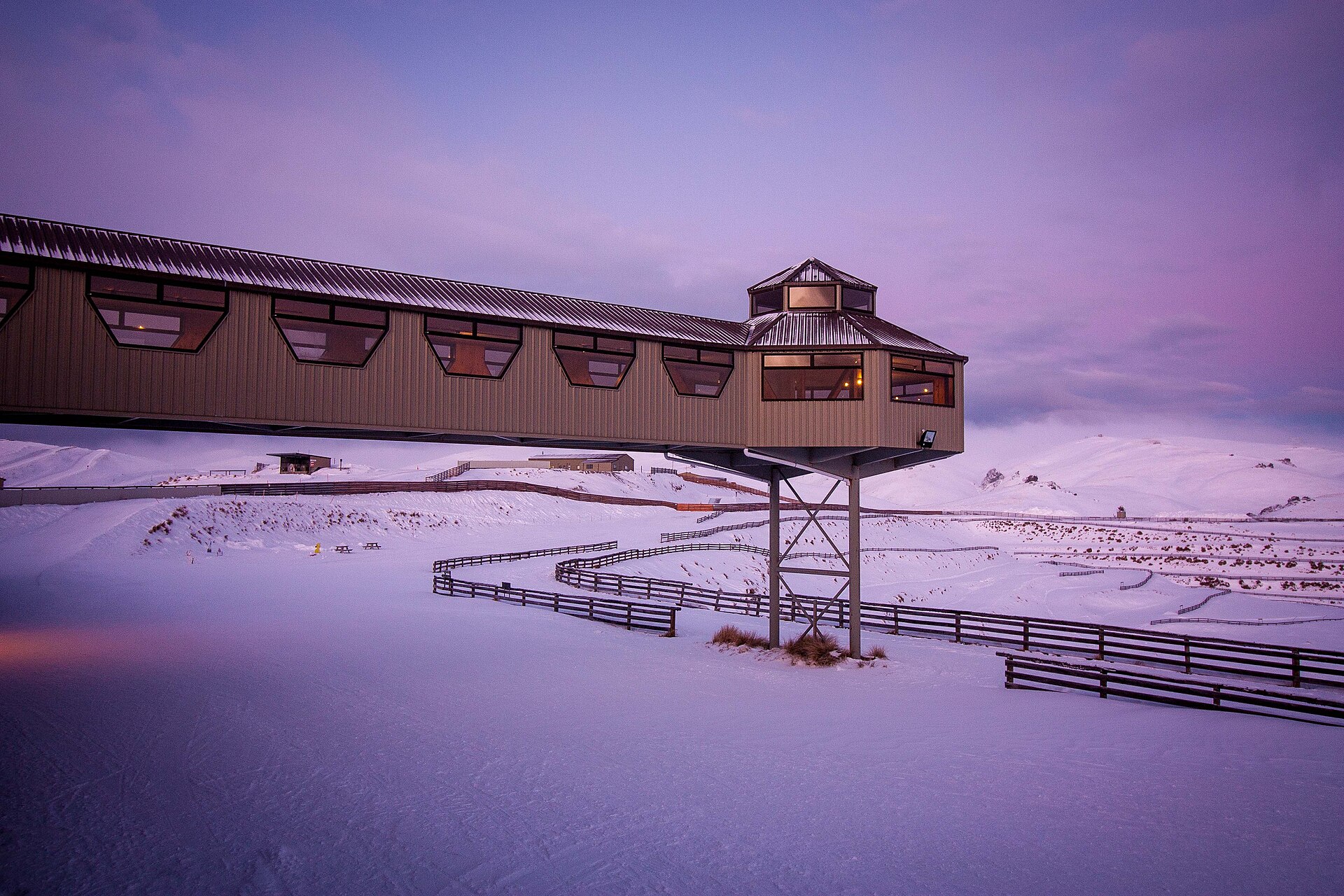 Snow Farm's main building surrounded by snow under a purple evening sky