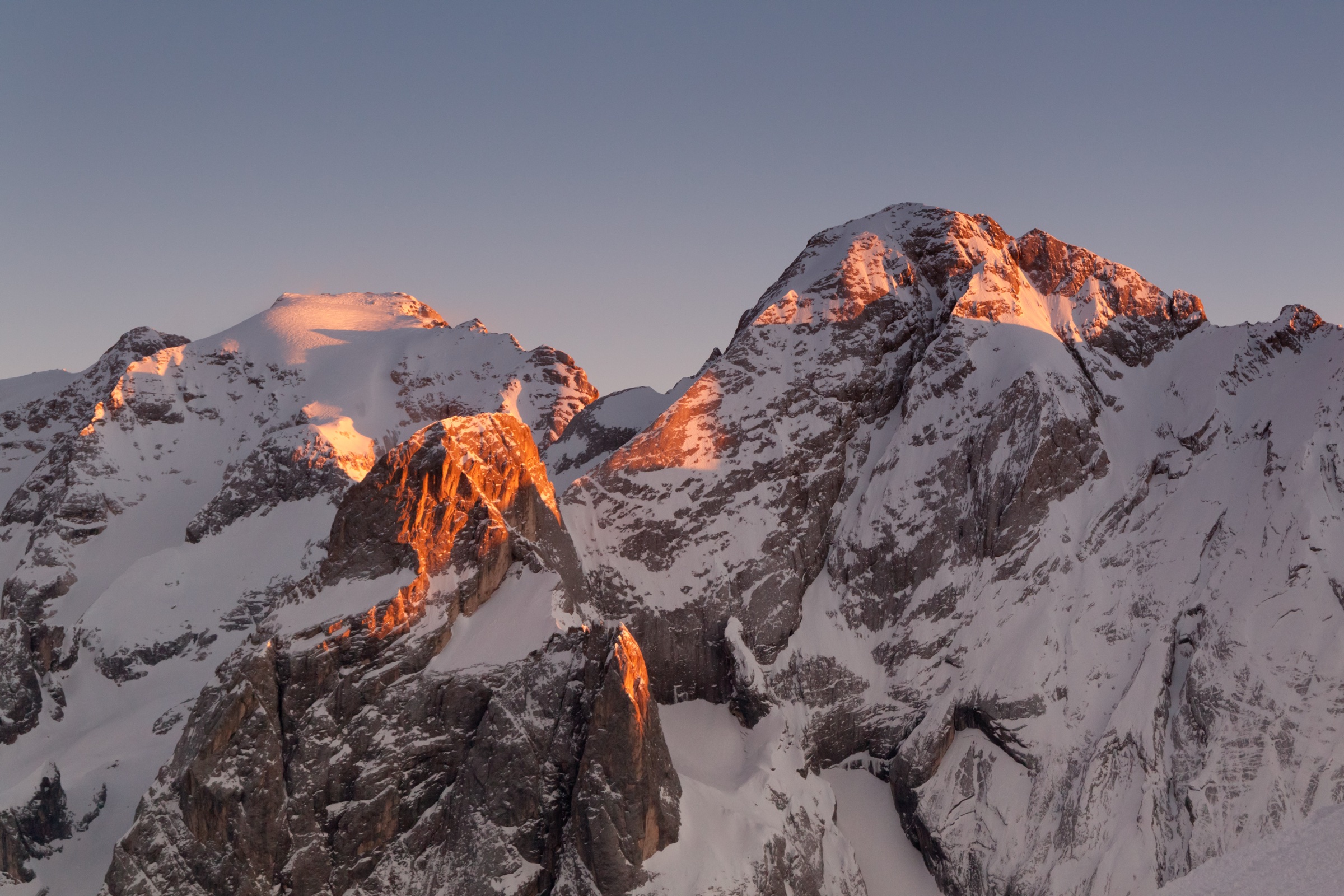 The Marmolada summit ridge — the Dolomites' highest peak, host to several classic via ferratas — glowing at sunset