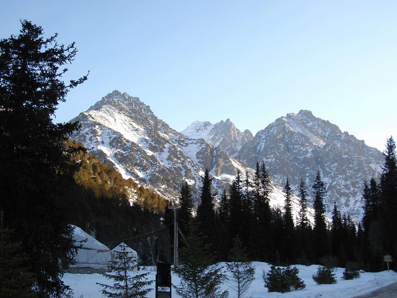 Snow-covered mountains and dark spruce forest in Ala-Archa National Park