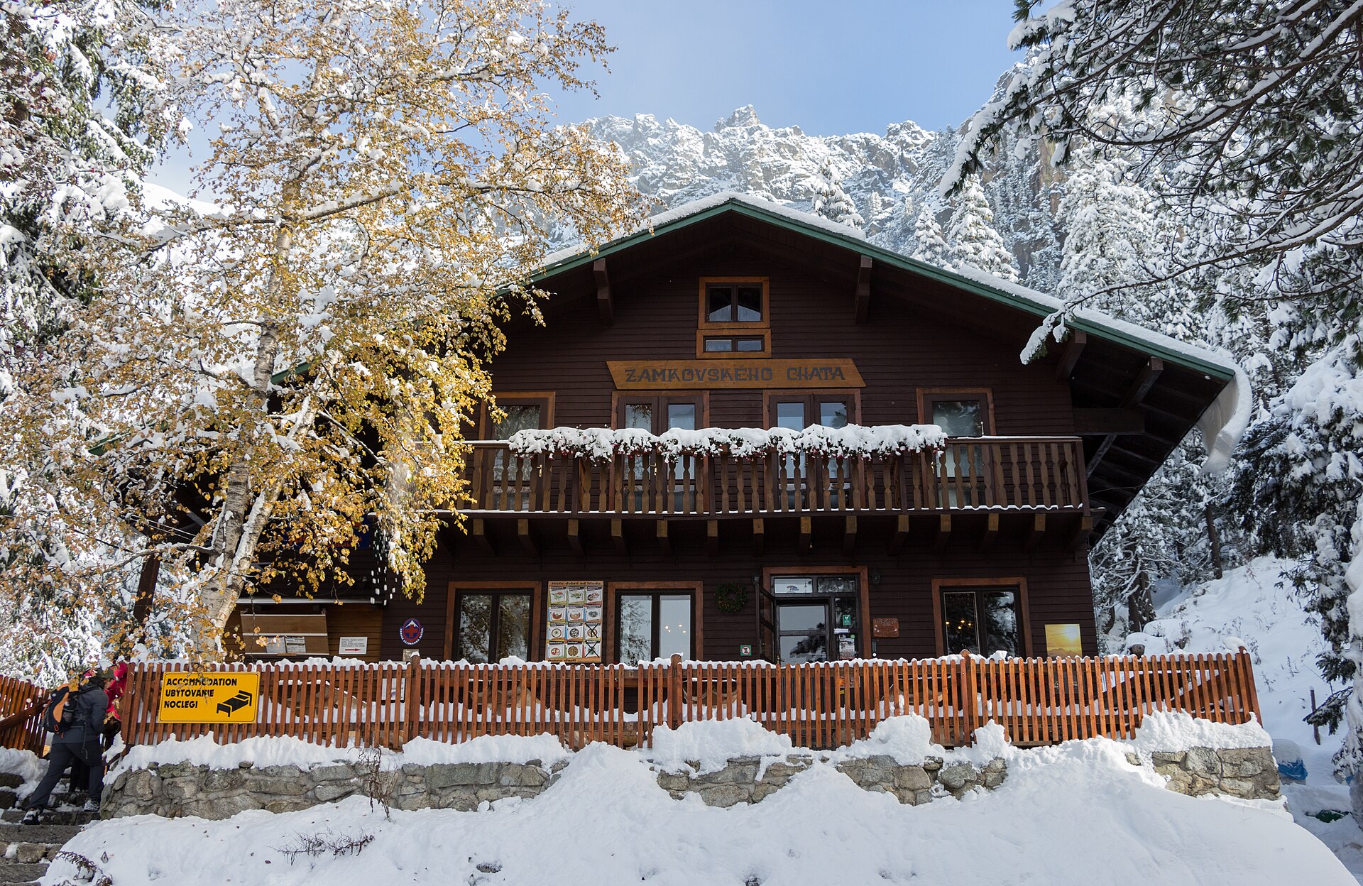 Zamkovského Chata surrounded by deep snow and mountain forest