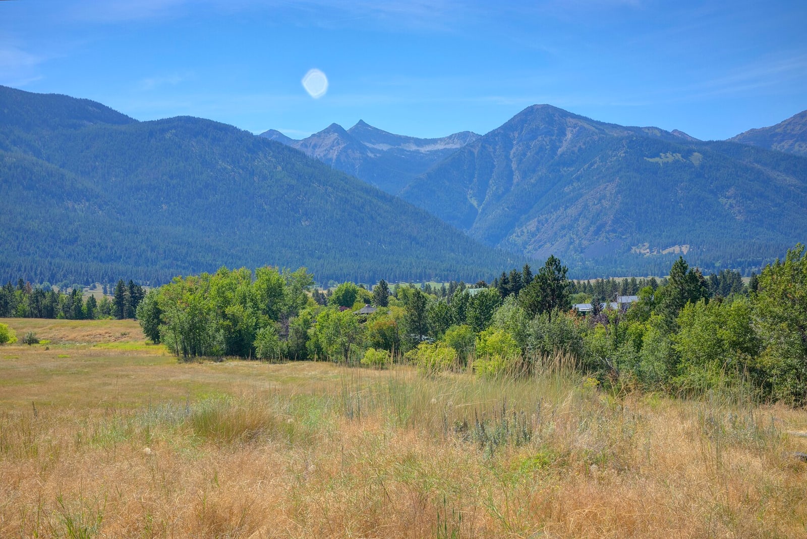 Open grassland and mountains at Iwetemlaykin State Heritage Site