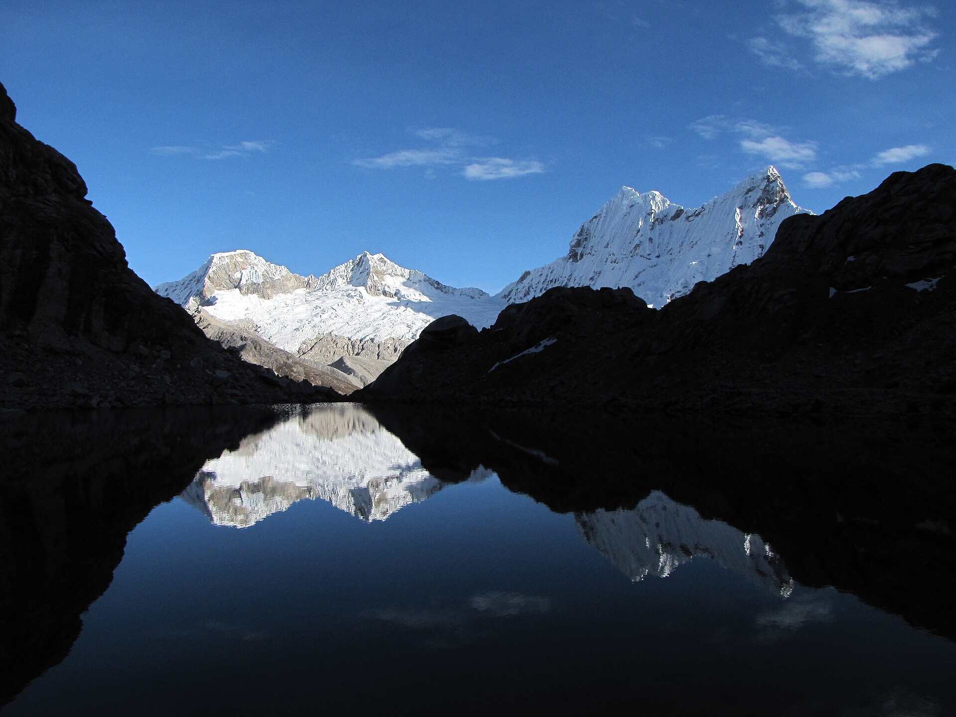 Pisco and Chacraraju reflected in a still high-Andean lake