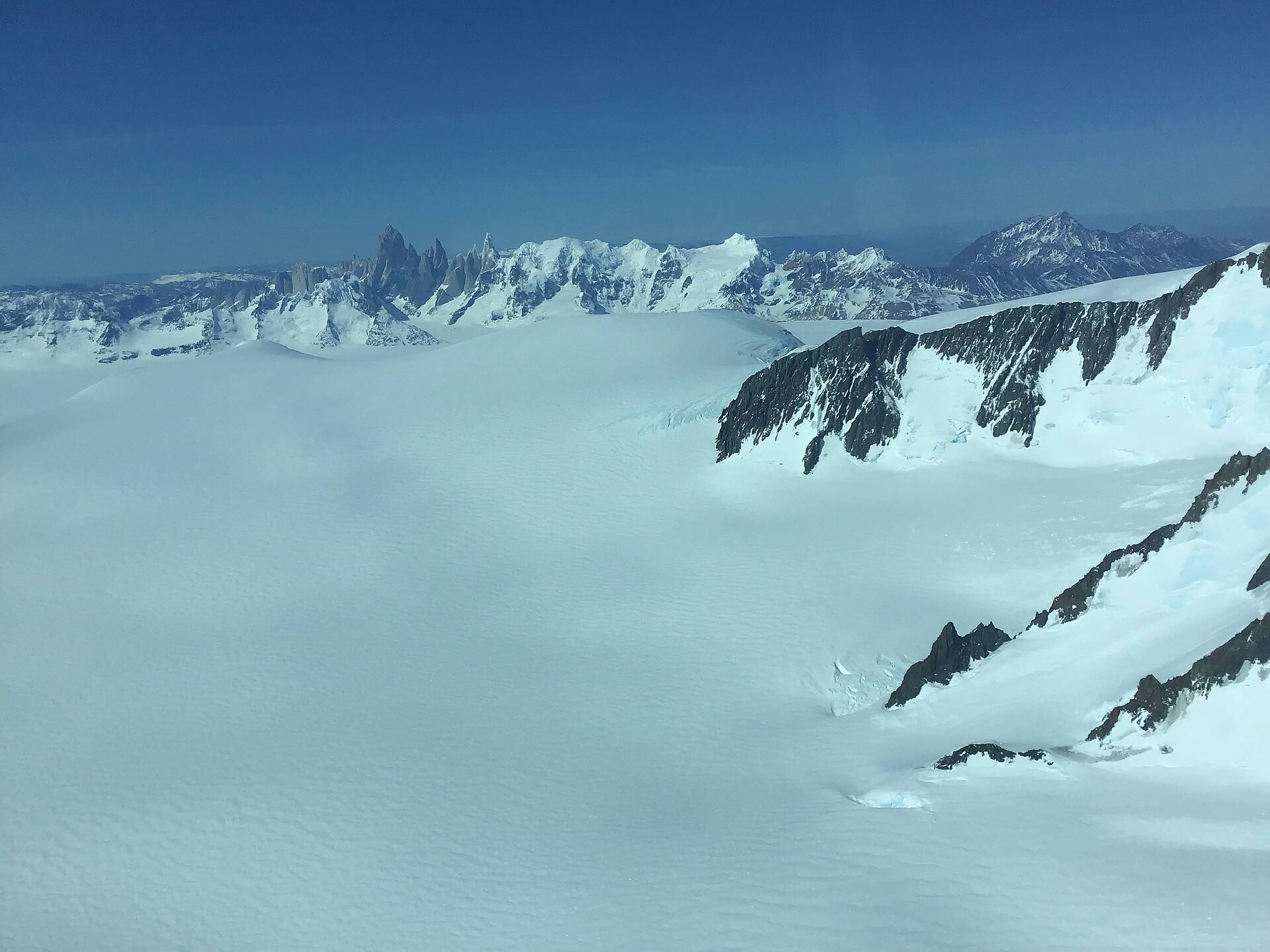 Aerial view across the vast white plateau and nunataks of the Southern Patagonian Ice Field