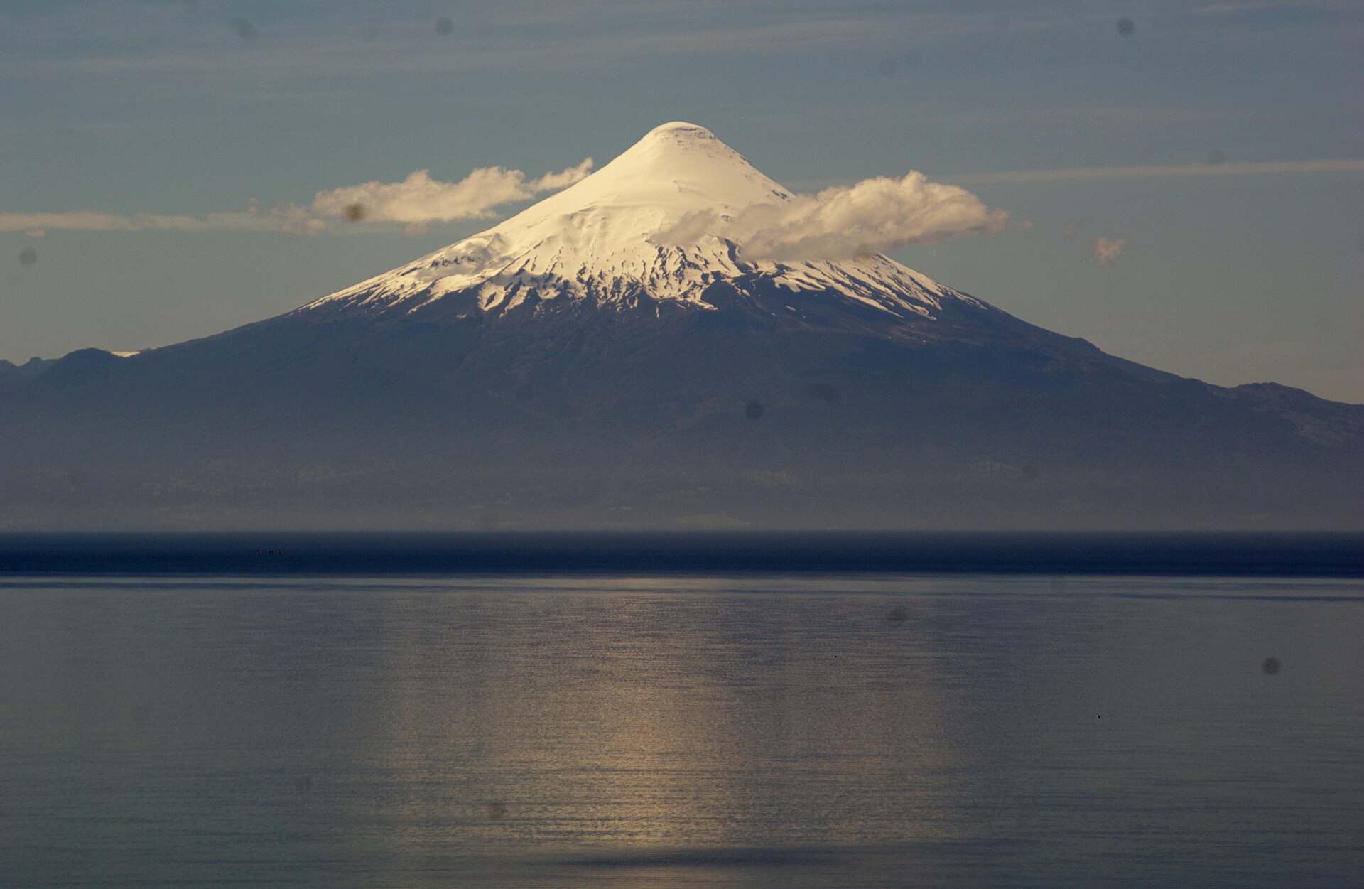 Snow-capped Osorno volcano rising across the calm water of Lake Llanquihue